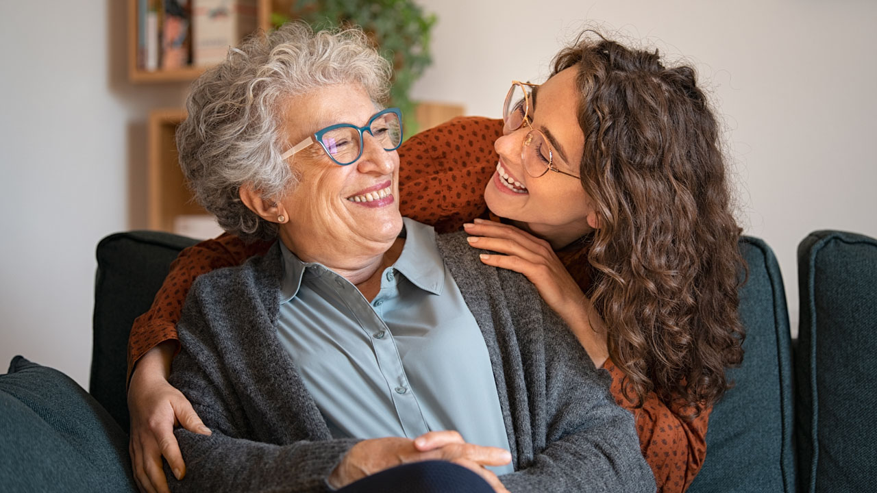 Her daughter hugging her behind