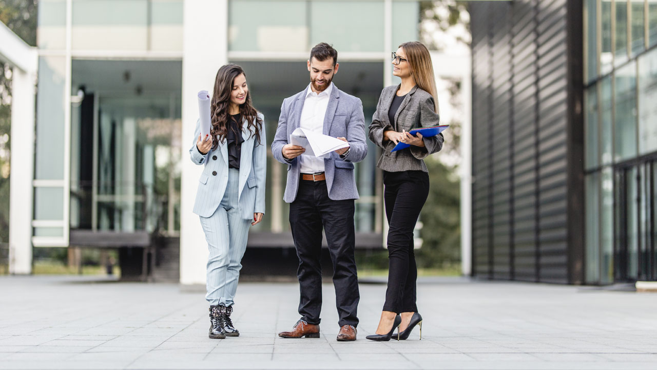 Three professional standing and having a talk