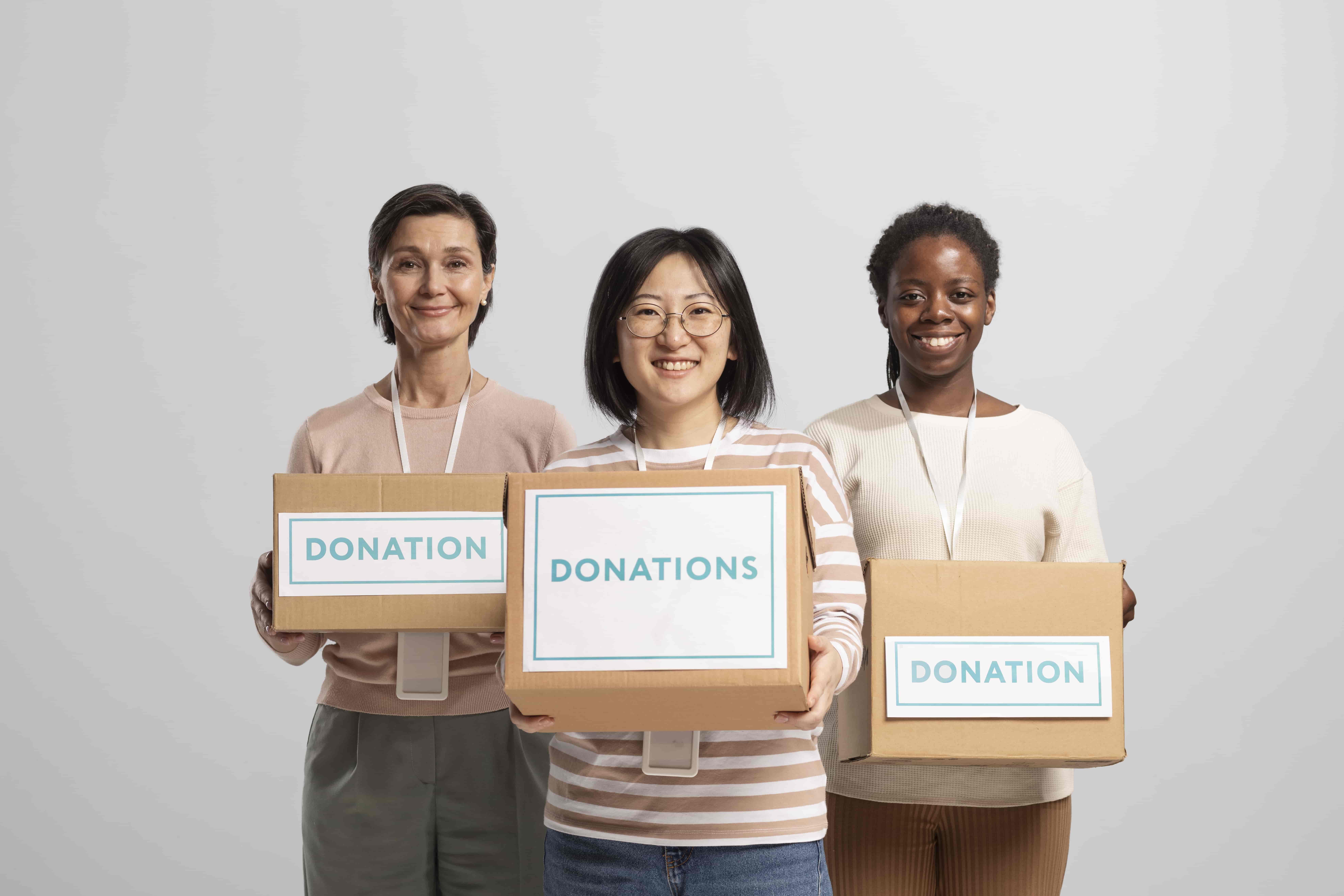 Volunteers holding boxes containing donations charity